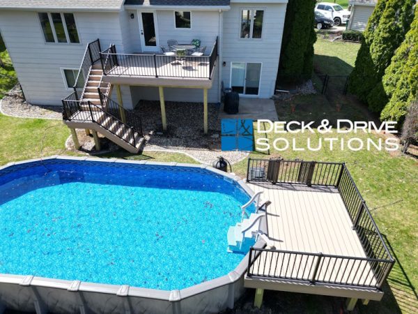 Overview of a backyard with new Trex deck and Trex pool deck around an above ground pool