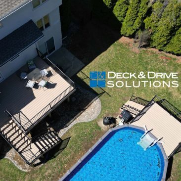 Overview of a backyard with new Trex deck and Trex pool deck around an above ground pool